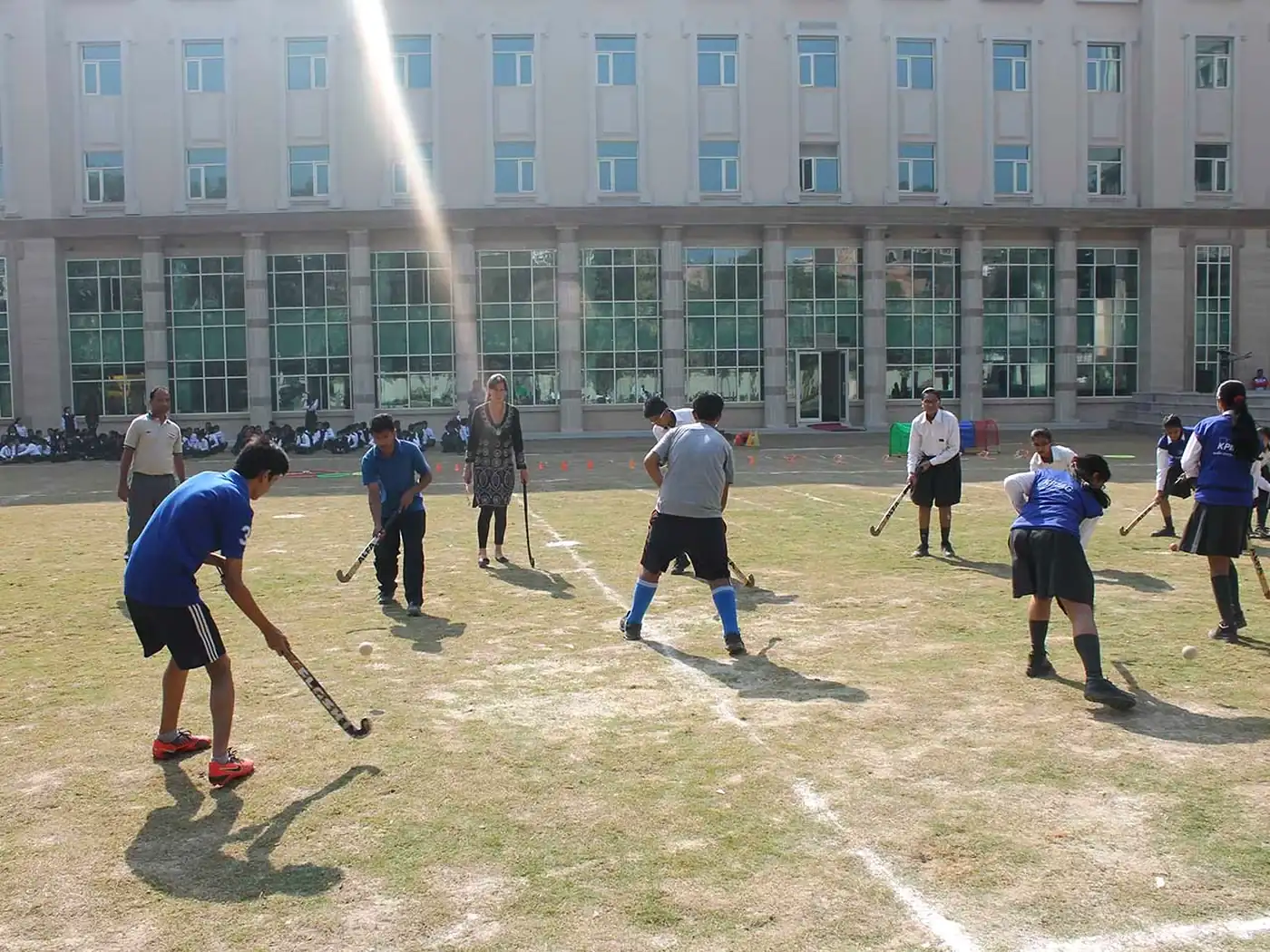 Students playing hockey on the school field