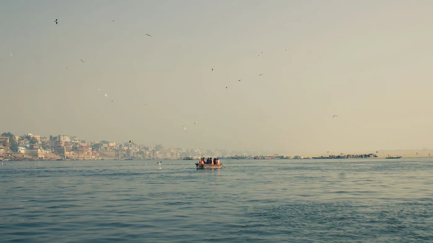 the Ganges at first light, a boat on open water
